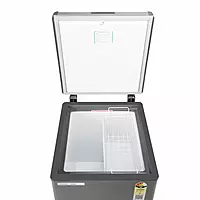 A person easily opening the spring-loaded lid of the Voltas CVF120SA3-P1-GW freezer.