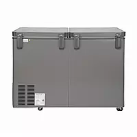 A person easily moving the Voltas deep freezer using its built-in mobility rollers.