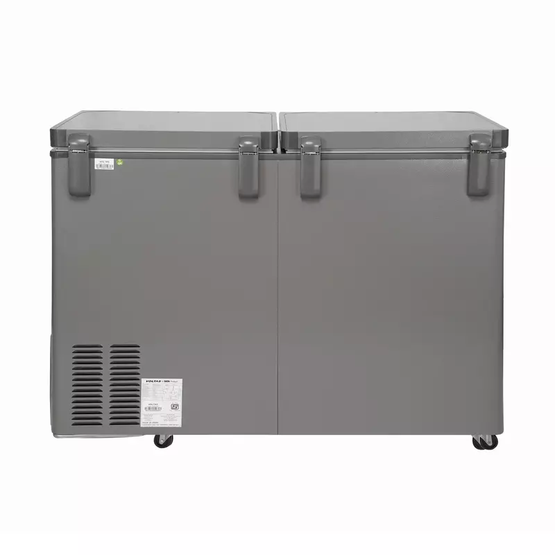 A person easily moving the Voltas deep freezer using its built-in mobility rollers.