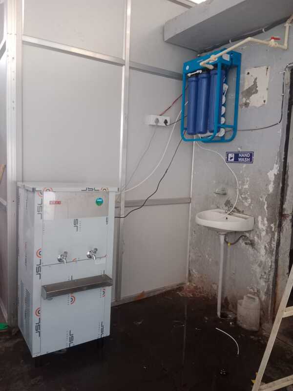 A technician installing the Power Jal Pro Stream 50 A in a spacious kitchen.