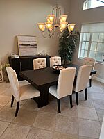 Mahogany dining table with cushioned  chairs.