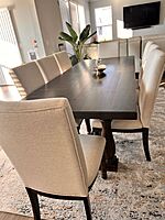 Mahogany dining table with cushioned  chairs.