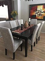 Mahogany dining table with cushioned  chairs.