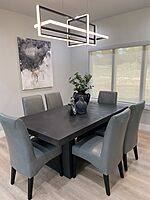 Mahogany dining table with cushioned  chairs.