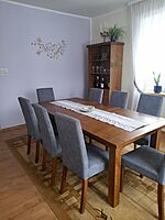 Mahogany dining table with cushioned  chairs.