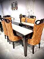 Mahogany dining table with cushioned  chairs.