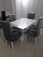 Mahogany dining table with cushioned  chairs.