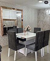 Mahogany dining table with cushioned  chairs.