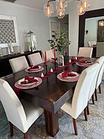 Mahogany dining table with cushioned  chairs.