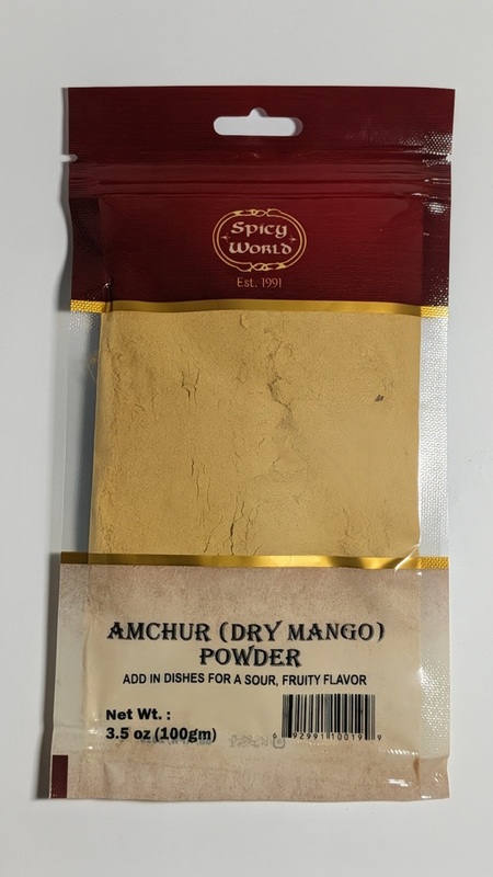 3.5oz jar of Spicy World Amchur Powder, a tangy and citrusy dried mango powder for Indian cooking.