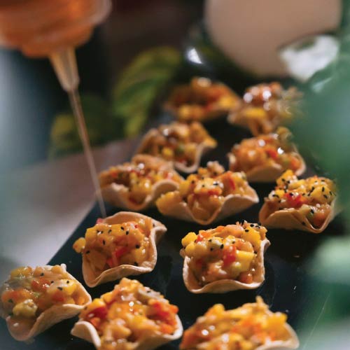 Salmon mango ceviche tostada at LOriental backarea drizzled with honey by chef