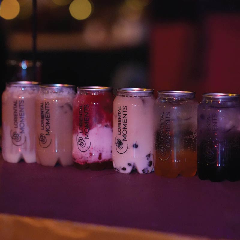 LOriental branded sealed cans filled with colourful boba creations for a theatrical non-alcoholic event bar