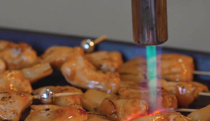 Shrimp skewers torched before plating