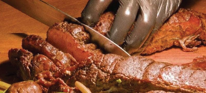 Chef carving tenderloin to order at a premium catering station
