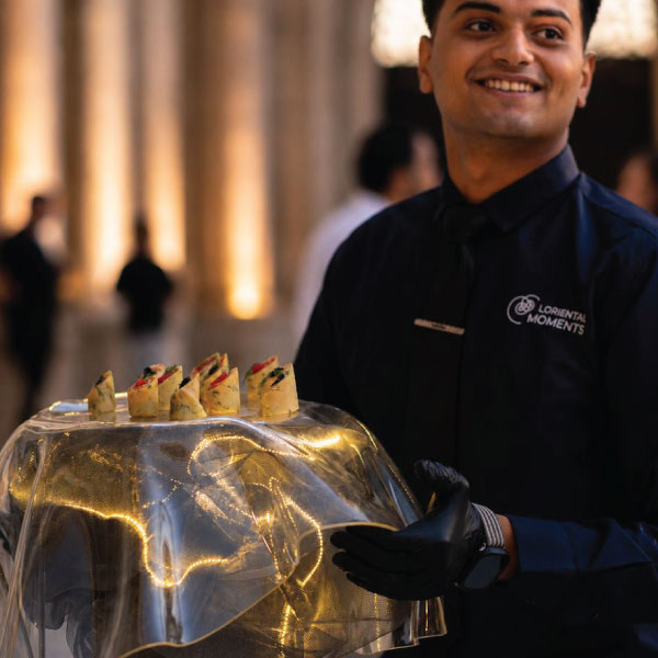 LOriental waiter carrying Aether Veil, one of LOriental signture theatrical presentation platforms at katb ketab event on 20 May 2026 LOriental waiter carrying Aether Veil, one of LOriental signture theatrical presentation platforms at katb ketab event on 20 May 2026