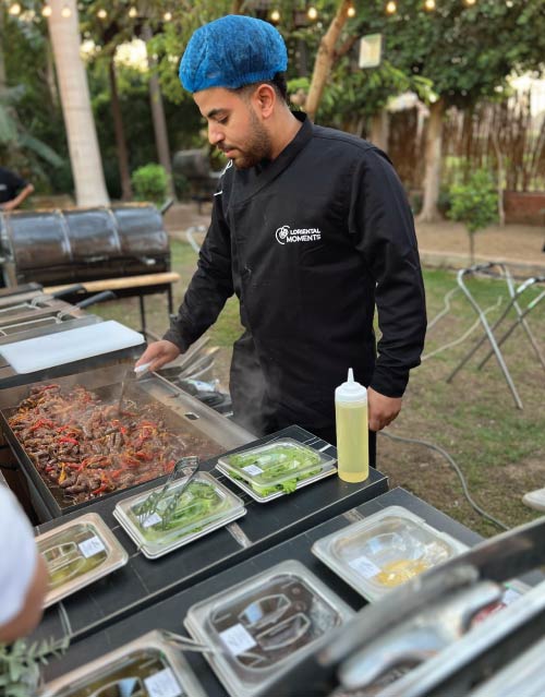 Chef preparing food on a live griddle station at the YouTube Shorts Creator event in Prince Naguib Palace on Dahab Island